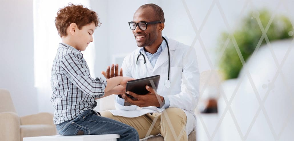 Clinician and child patient interacting with each other and mobile tablet