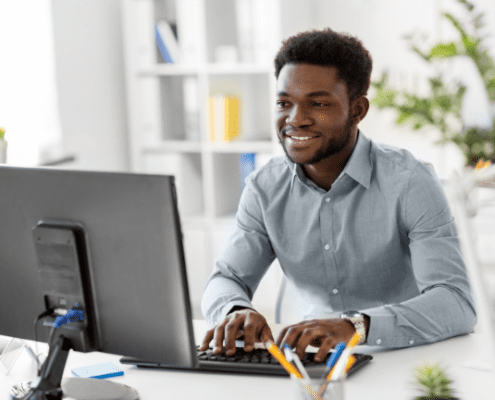 man sitting at desk typing