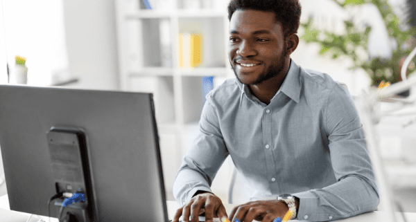 man sitting at desk typing