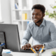 man sitting at desk typing