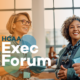 Two professionals at a conference with "HCAA Exec Forum" text overlay.