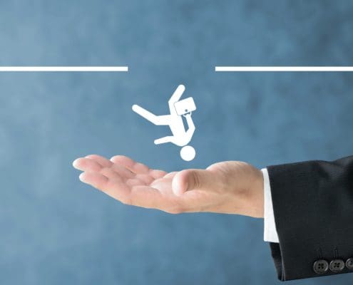 Hand of a business professional catching a graphic, representing compliance monitoring pitfalls