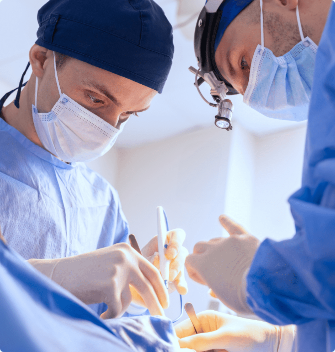Two male surgeons complete a surgery at a hospital.